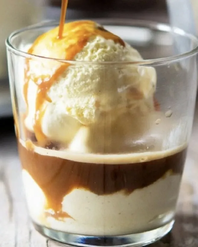 Affogato with a scoop of gelato and caramel in a glass